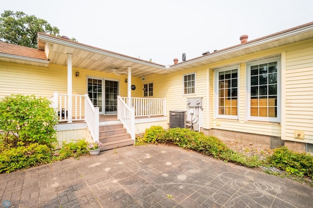 property entrance featuring a patio and cooling unit