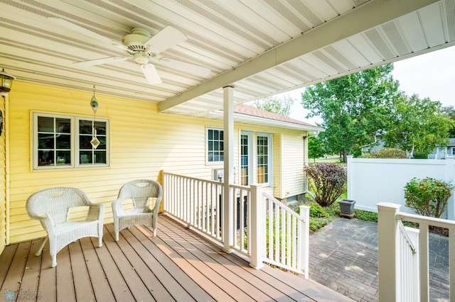 deck featuring ceiling fan and fence