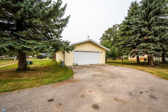 exterior space with a yard, a garage, and an outdoor structure