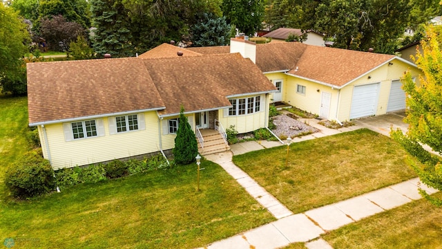 view of front of property featuring a garage, a chimney, a front lawn, and a shingled roof