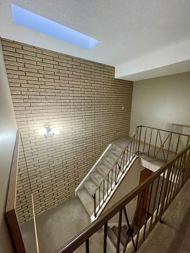 stairway with a textured ceiling