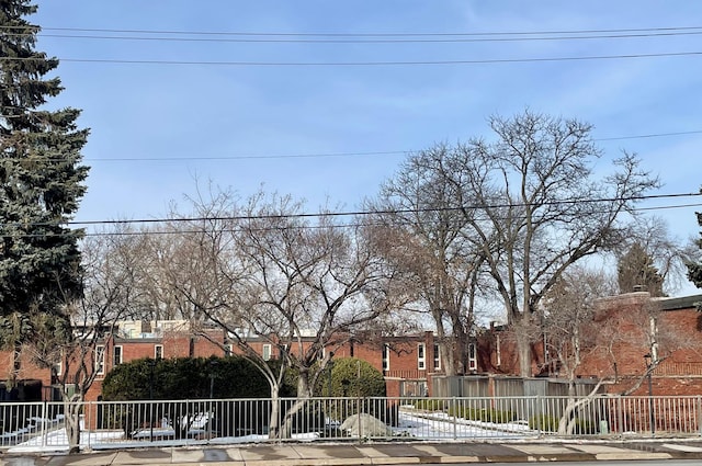 view of front facade with brick siding and a fenced front yard