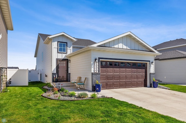 view of front facade with an attached garage, board and batten siding, a front yard, a gate, and driveway