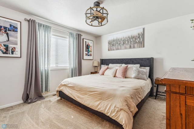 bedroom featuring light carpet and baseboards