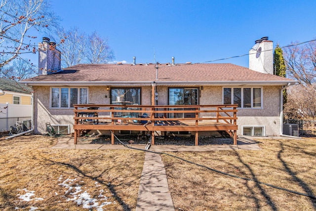 3879 Polk St NE, Columbia Heights, MN 55421 - rear view of house with a deck, stucco siding, fence, and a chimney