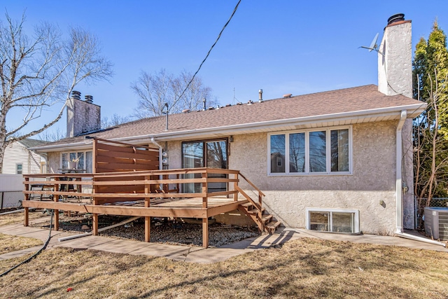 3879 Polk St NE, Columbia Heights, MN 55421 - rear view of house featuring a chimney, a wooden deck, stucco siding, and central AC unit