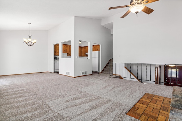 3879 Polk St NE, Columbia Heights, MN 55421 - unfurnished living room with baseboards, visible vents, ceiling fan with notable chandelier, and lofted ceiling