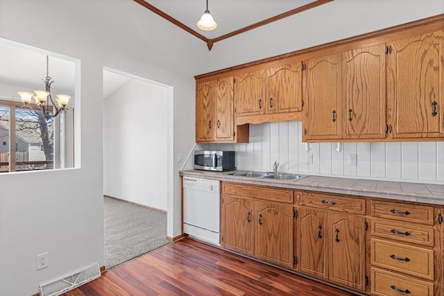 3879 Polk St NE, Columbia Heights, MN 55421 - kitchen featuring stainless steel microwave, white dishwasher, a sink, dark wood-style floors, and visible vents