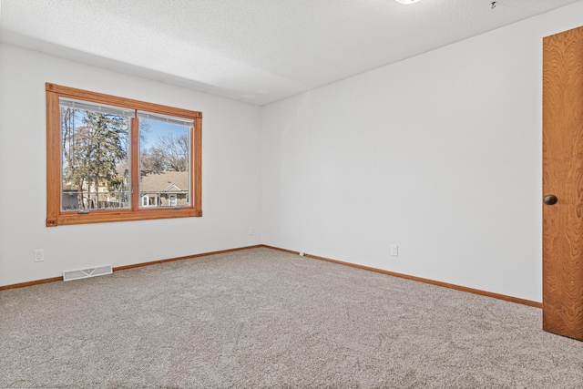 3879 Polk St NE, Columbia Heights, MN 55421 - spare room featuring carpet, visible vents, a textured ceiling, and baseboards