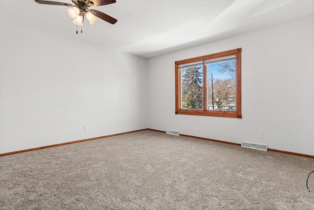 3879 Polk St NE, Columbia Heights, MN 55421 - unfurnished room with a ceiling fan, visible vents, carpet floors, and baseboards