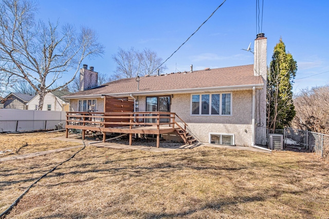 3879 Polk St NE, Columbia Heights, MN 55421 - rear view of house with a lawn, a wooden deck, a fenced backyard, and a chimney