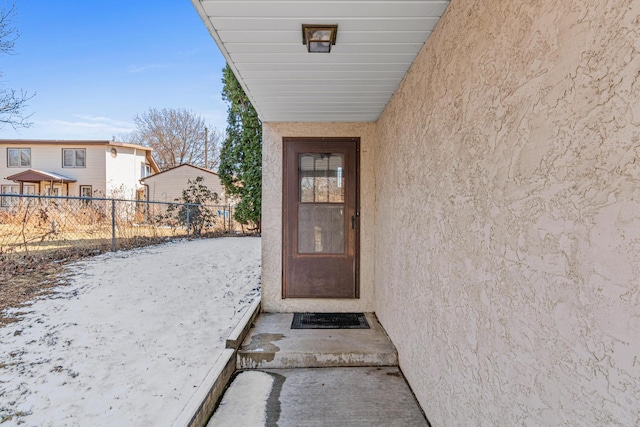 3879 Polk St NE, Columbia Heights, MN 55421 - doorway to property featuring fence and stucco siding