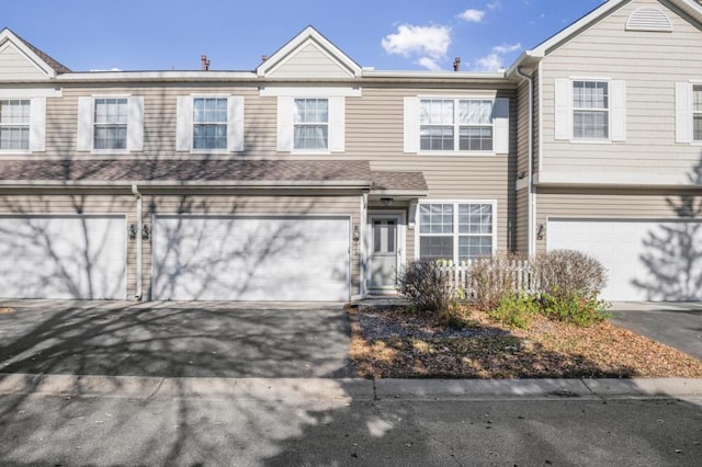 view of property featuring driveway and an attached garage