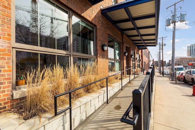 view of side of property featuring brick siding