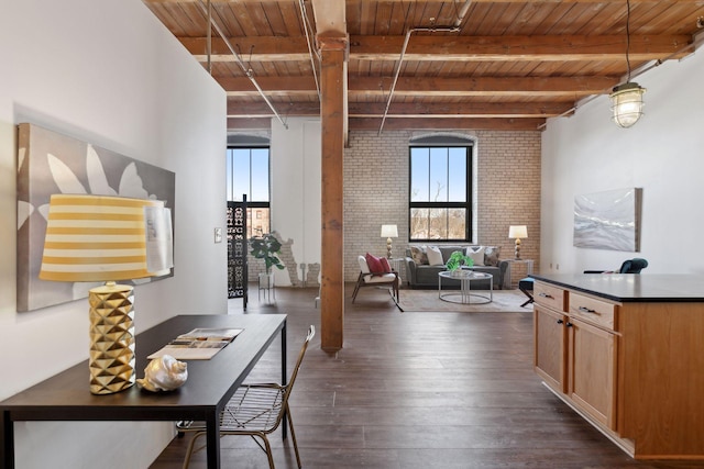 interior space featuring dark wood-type flooring, wooden ceiling, beamed ceiling, and brick wall