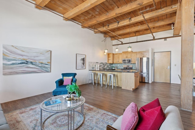 living area with wood ceiling, beam ceiling, track lighting, and dark wood-type flooring