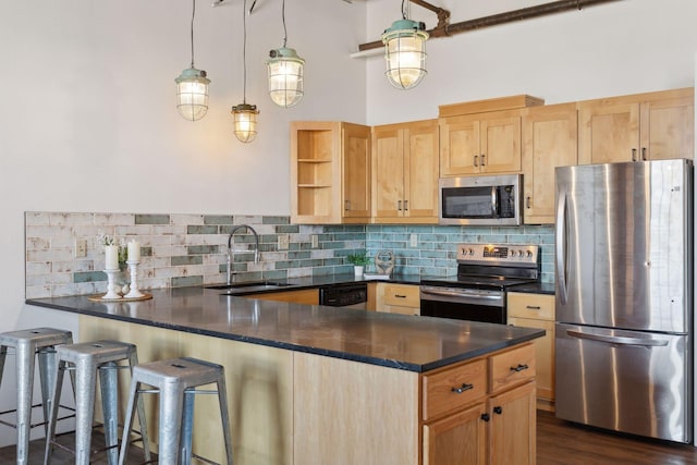 kitchen with open shelves, appliances with stainless steel finishes, light brown cabinets, a sink, and a peninsula