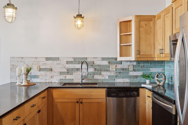 kitchen with appliances with stainless steel finishes, dark countertops, and a sink