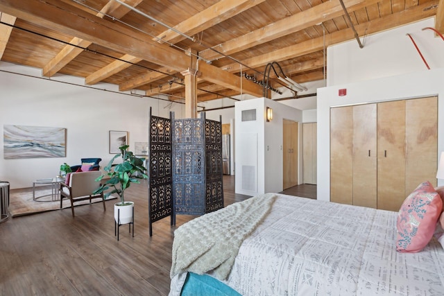 bedroom featuring visible vents, wooden ceiling, wood finished floors, freestanding refrigerator, and beamed ceiling