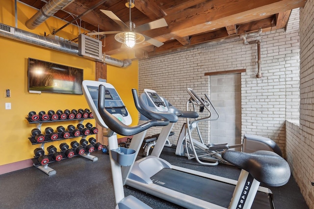 workout area featuring brick wall