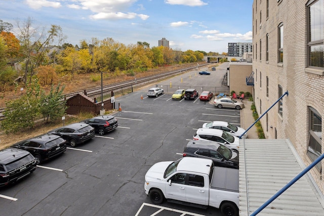 uncovered parking lot featuring a view of city