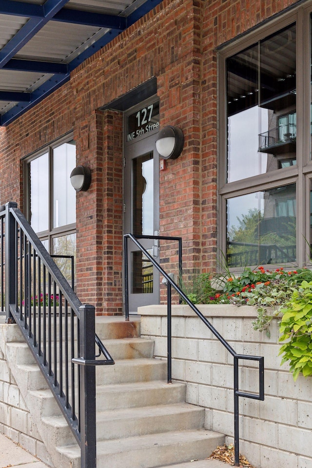 property entrance featuring brick siding