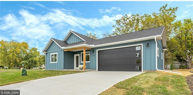 view of front of home featuring a garage, concrete driveway, a front lawn, and board and batten siding