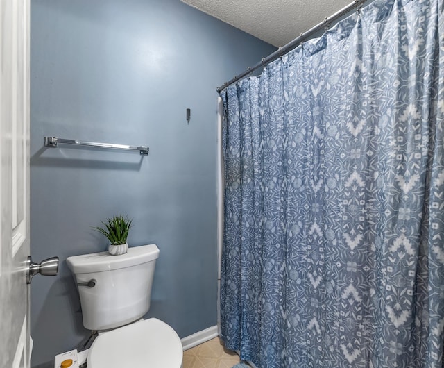 full bathroom with toilet, curtained shower, baseboards, and a textured ceiling