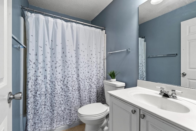 bathroom with toilet, curtained shower, a textured ceiling, and vanity