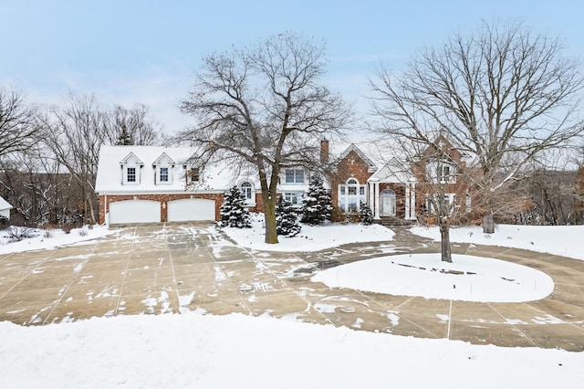 snowy yard featuring a garage