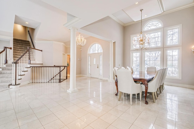 dining space featuring an inviting chandelier, decorative columns, and a wealth of natural light