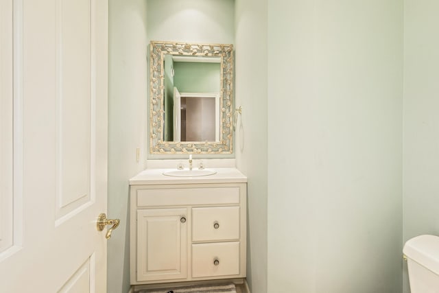 half bath with vanity and toilet