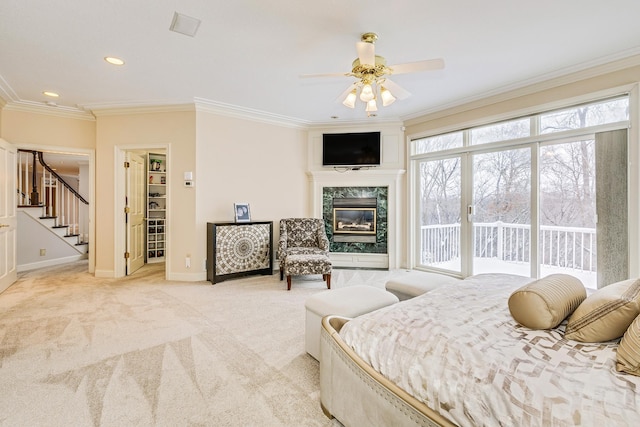 bedroom with light carpet, a high end fireplace, baseboards, access to outside, and crown molding