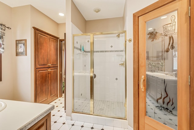 full bath featuring a shower stall, vanity, and tile patterned floors