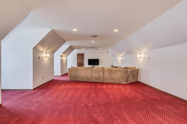 home theater with visible vents, baseboards, vaulted ceiling, a textured ceiling, and carpet floors