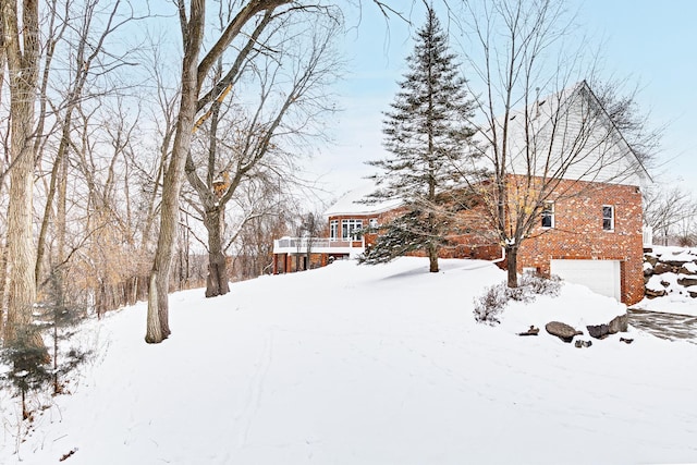 yard layered in snow with an attached garage