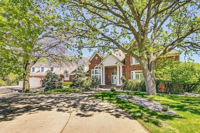 4680 152nd Ct NW, Ramsey, MN 55303 - traditional-style home featuring brick siding, concrete driveway, and a front lawn