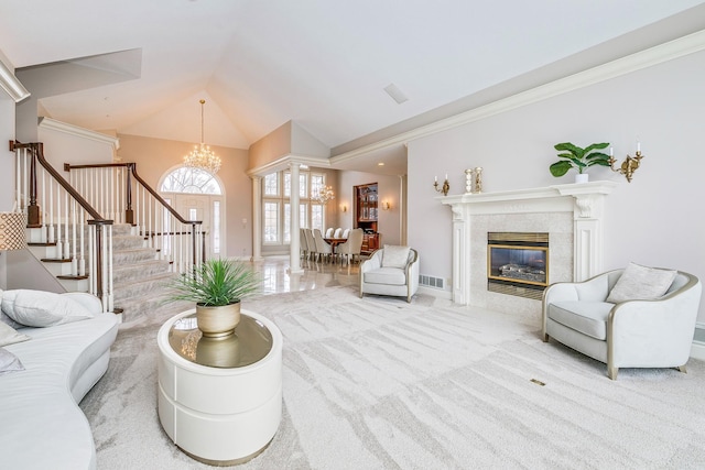 4680 152nd Ct NW, Ramsey, MN 55303 - carpeted living area with a chandelier, stairs, crown molding, a tiled fireplace, and high vaulted ceiling