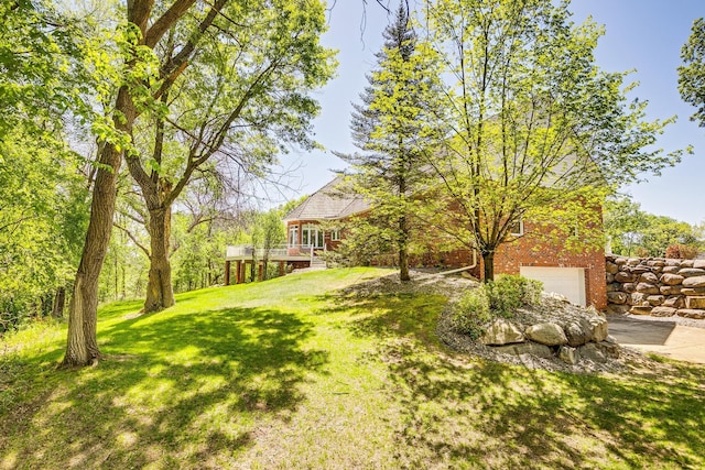 4680 152nd Ct NW, Ramsey, MN 55303 - view of green lawn featuring driveway, a garage, and a wooden deck