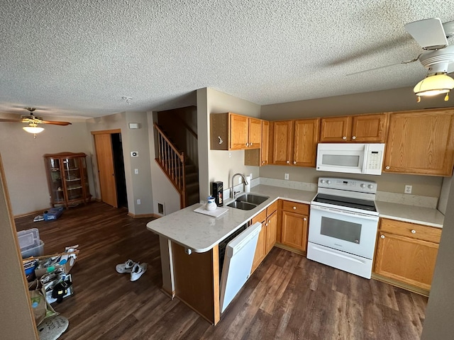 kitchen featuring dark wood-style flooring, white appliances, light countertops, and a sink