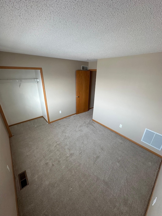 unfurnished bedroom featuring visible vents, baseboards, and carpet floors