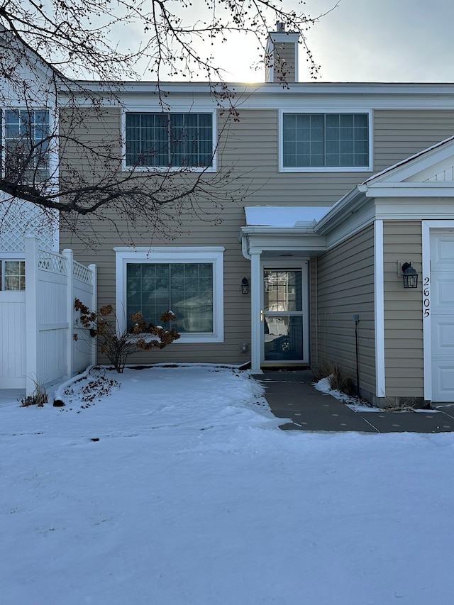 view of front of property with a chimney and fence