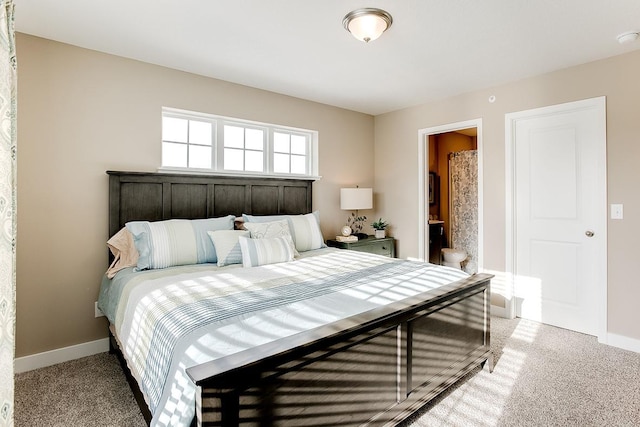 bedroom featuring light carpet and baseboards