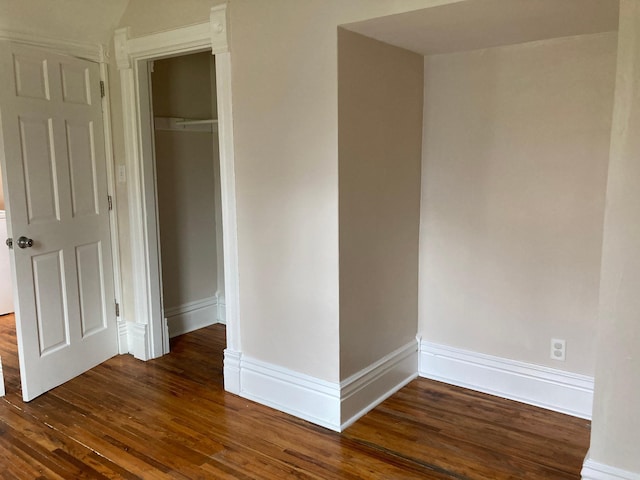 interior space featuring dark wood-style floors and baseboards