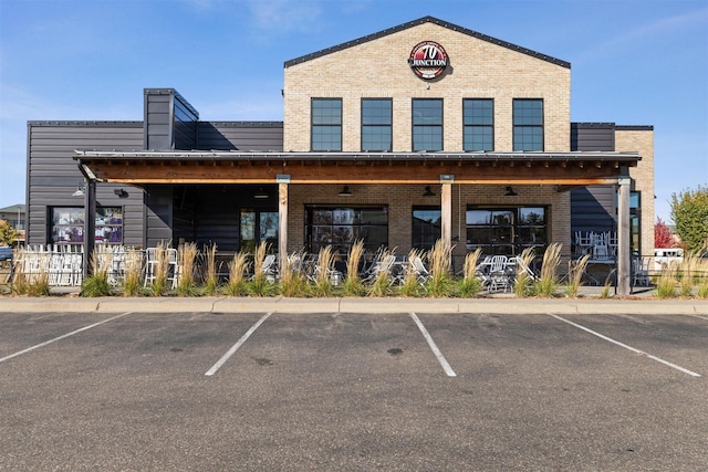 view of property with uncovered parking and fence