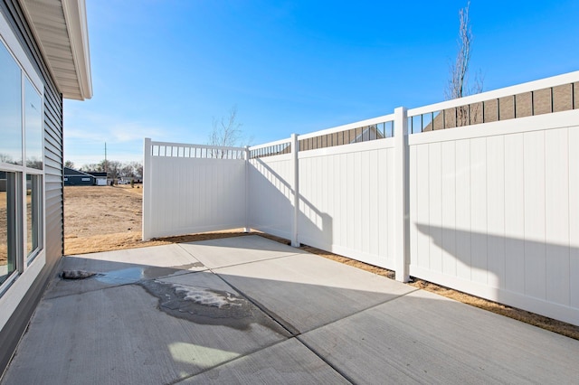 view of patio featuring fence