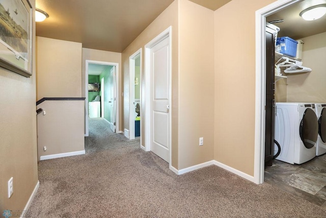 corridor featuring baseboards, separate washer and dryer, and carpet flooring