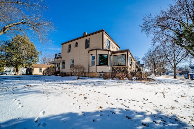 snow covered house with a chimney