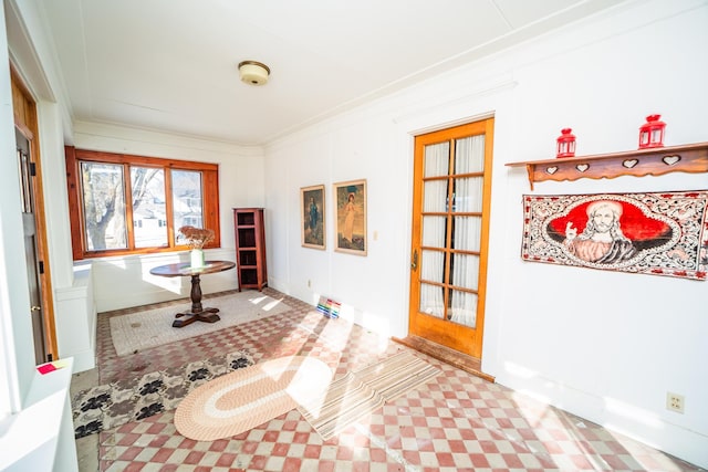 workout area featuring baseboards and ornamental molding