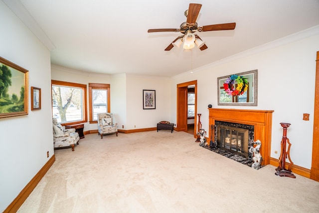 sitting room with ornamental molding, a high end fireplace, light carpet, and baseboards